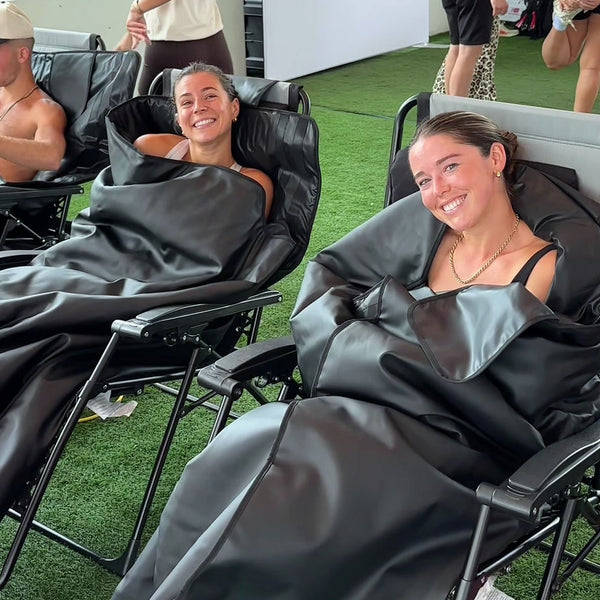 Two women relaxing in AWA HL500 sauna blankets